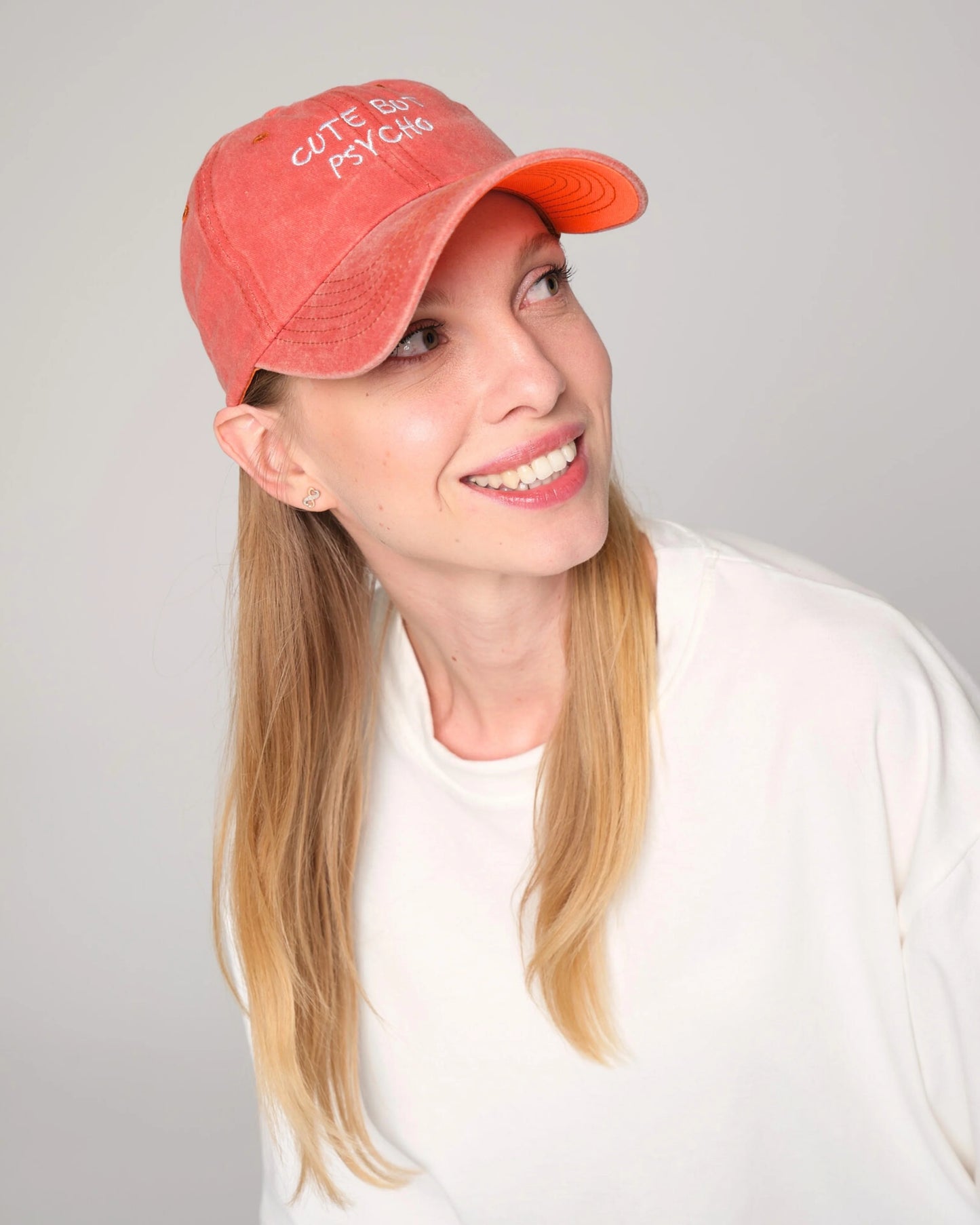 woman wearing Cute But Psycho Orange Washed Cap