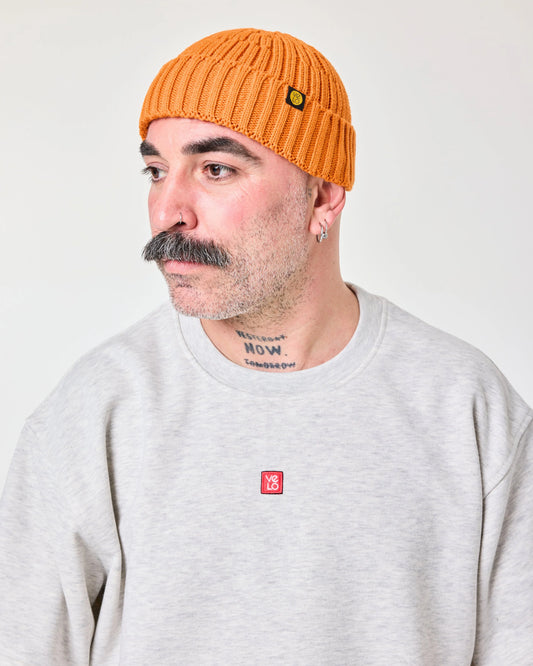 side view of a man wearing Orange Fisherman Beanie