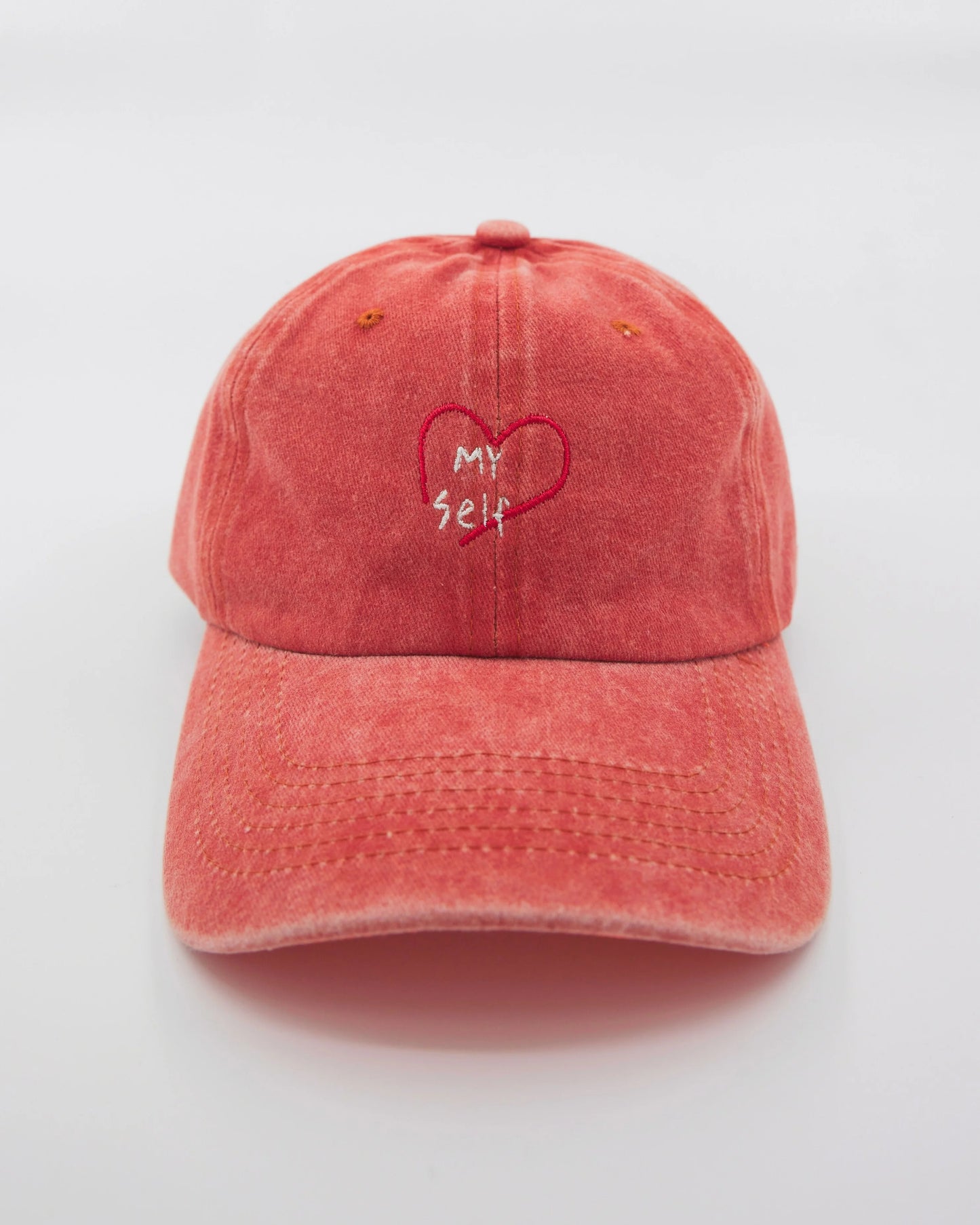 front view of Orange Washed Cap with Love Myself embroidered in white