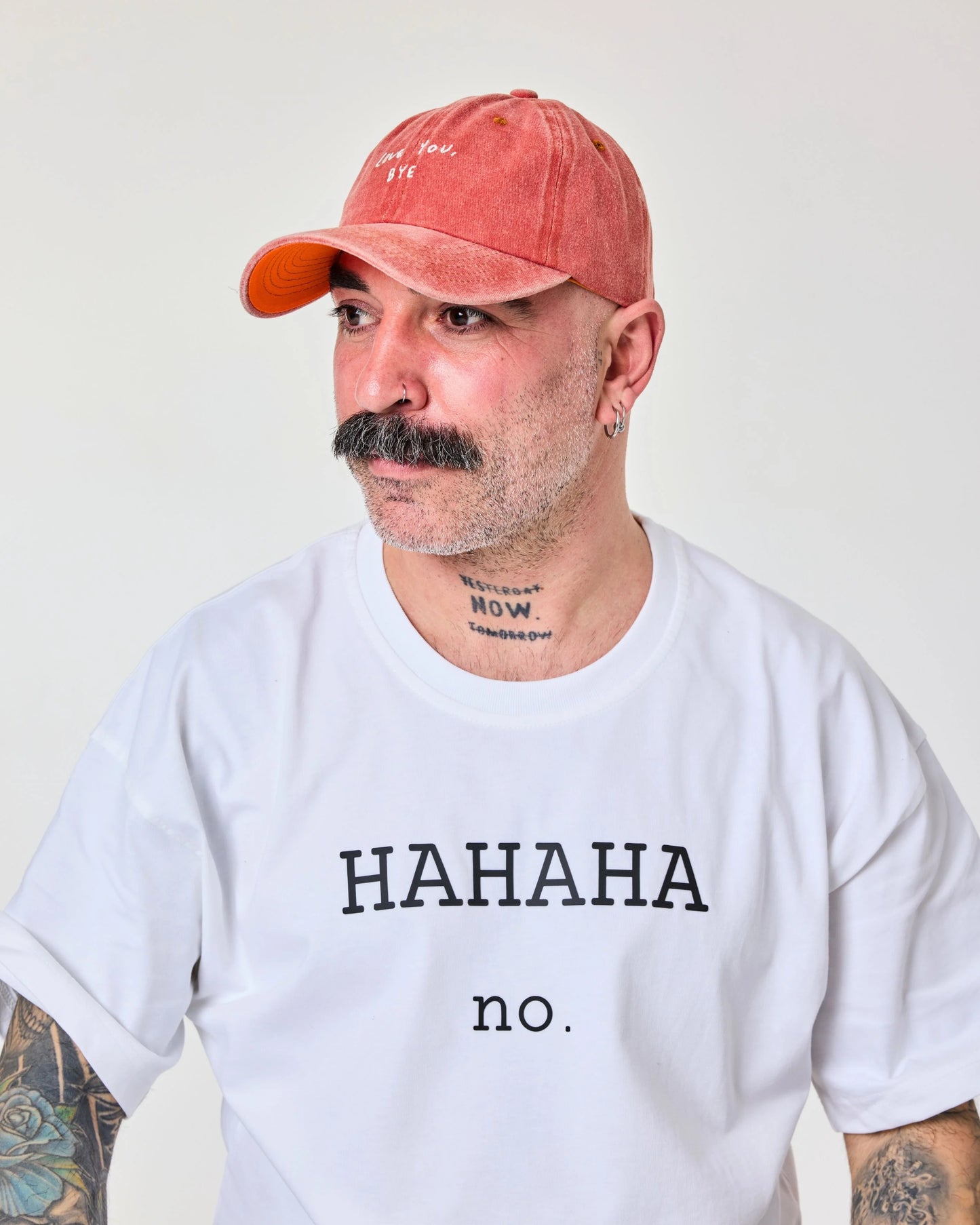 side view of a man wearing Love You Bye Orange Washed Cap