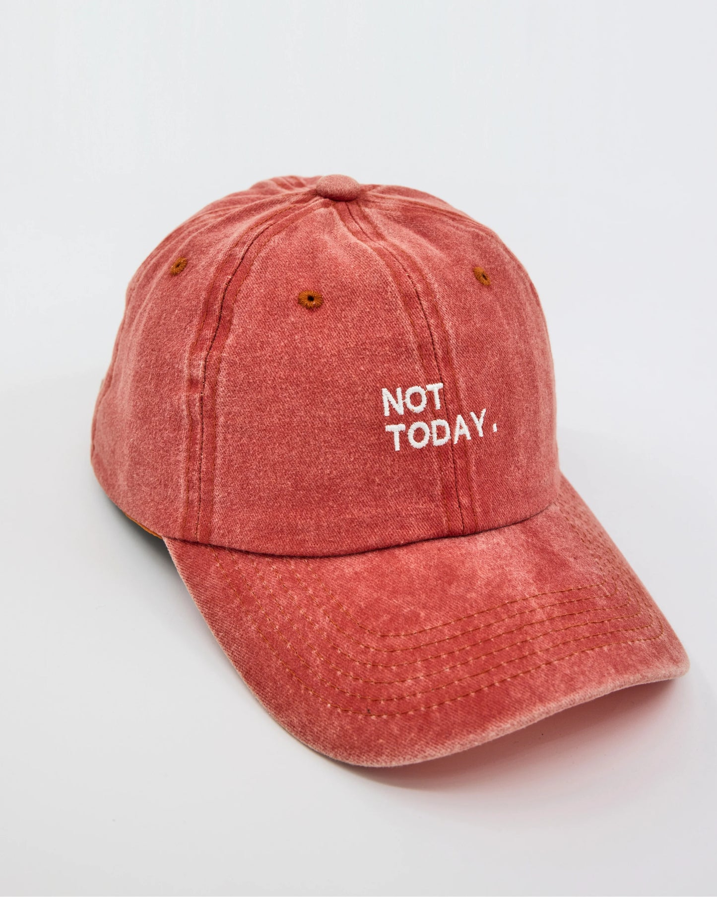 side view of Orange Washed Cap with Not Today embroidered in white