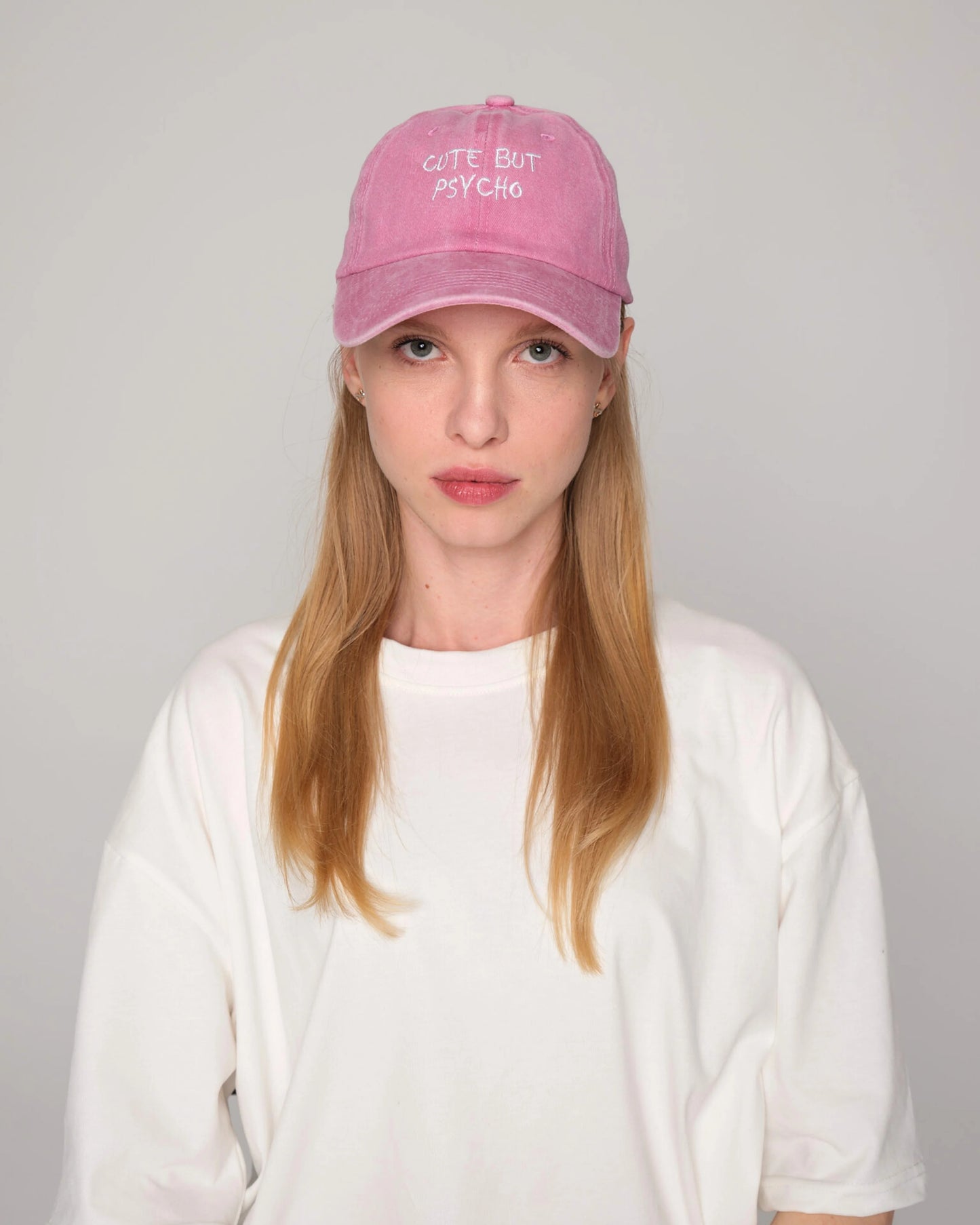 woman wearing Pink Cute But Psycho Washed Cap Hat