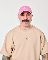 man wearing Pink Washed Cap with Not Today embroidered in white