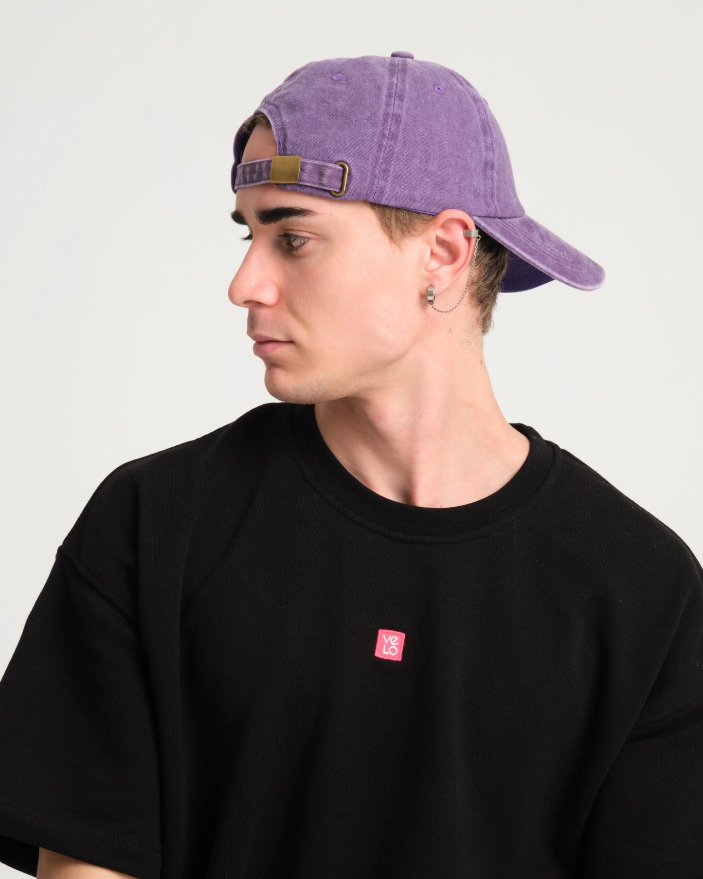 side view of a man wearing Cute But Psycho Purple Washed Cap