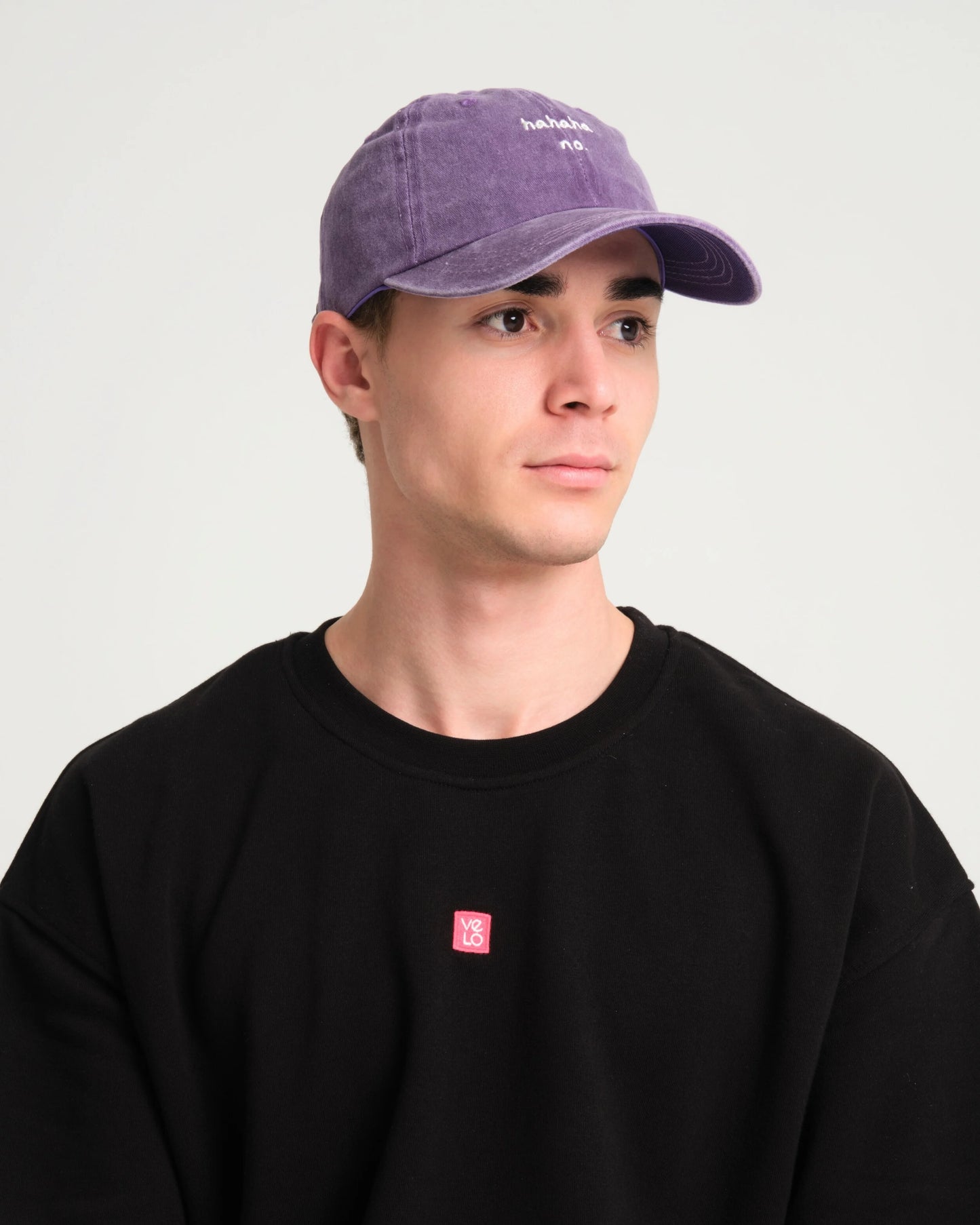 front view of a man wearing Hahaha No Purple Washed Cap