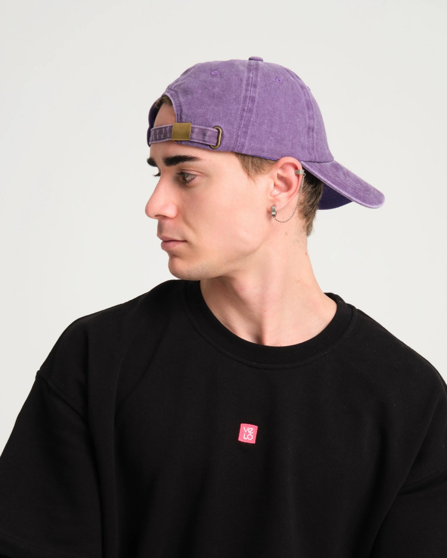 side view of a man wearing Hahaha No Purple Washed Cap