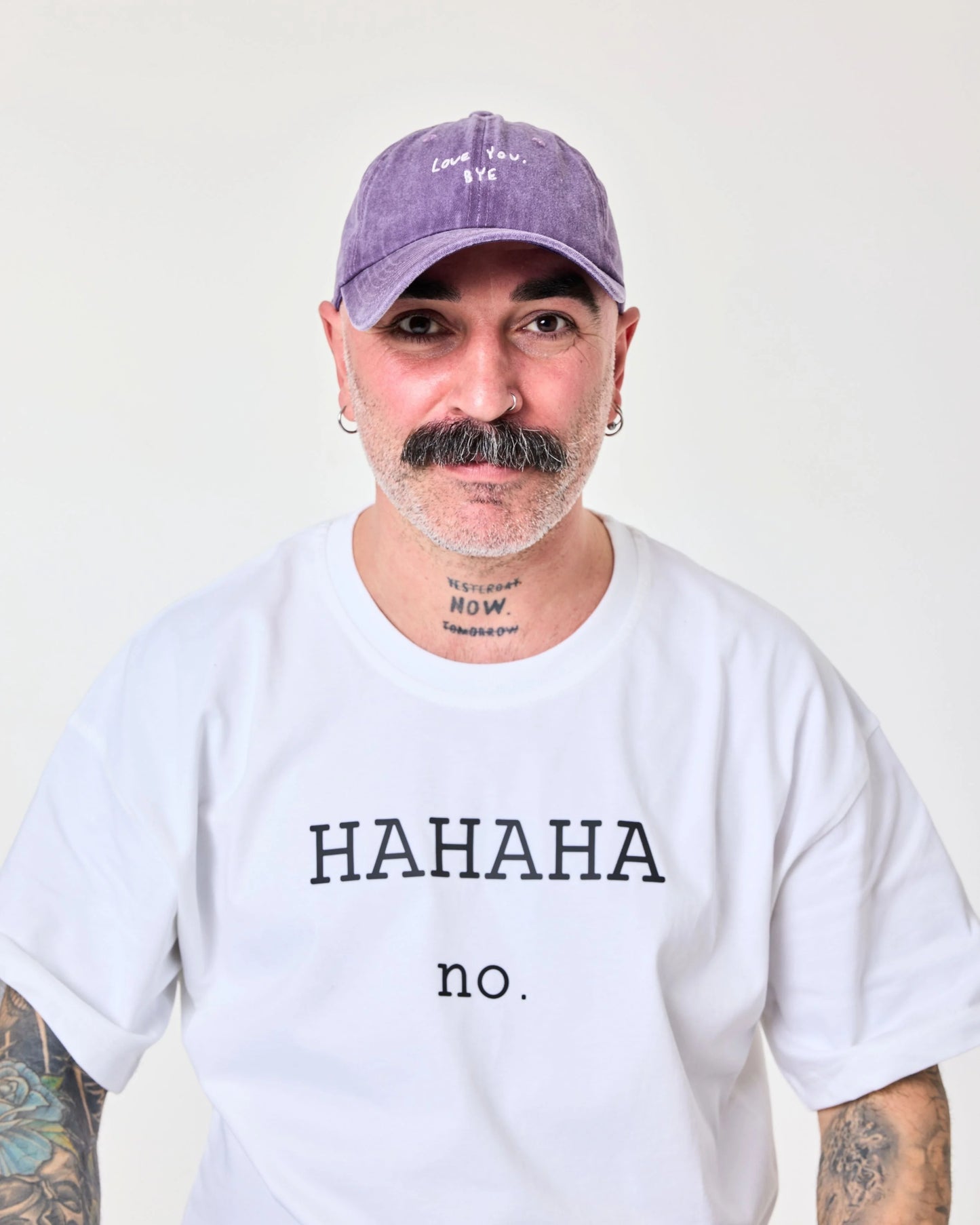 man wearing purple washed cap with 'Love You, Bye' embroidered in white.