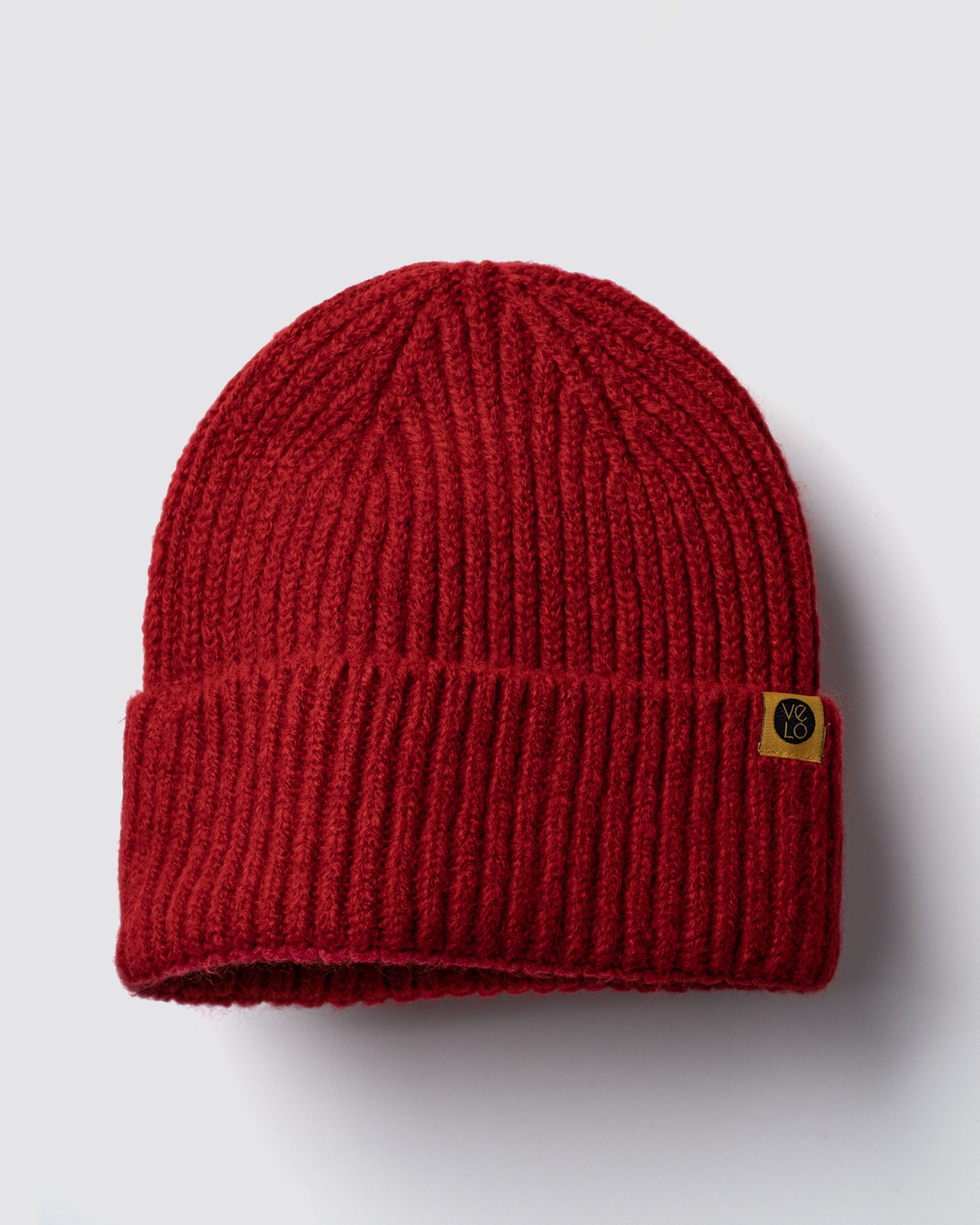 Red Lux Beanie on a light gray background