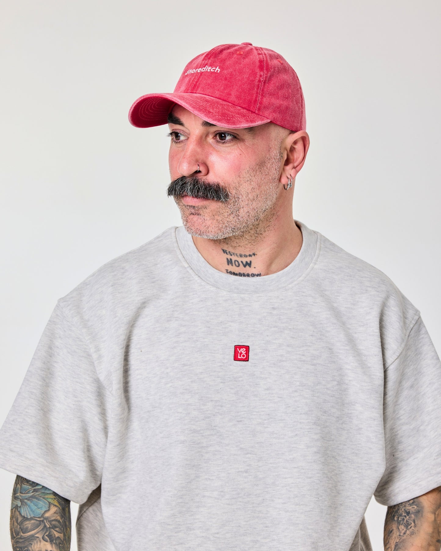 side view of a man wearing Shoreditch Red Washed Cap