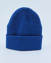 Royal blue beanie on a light blue background