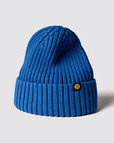 Royal blue knit beanie with a brand logo on a light gray background