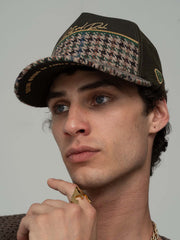 Man wearing Royalty Khaki Trucker Hat and pointing with his finger, against a plain background
