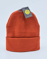 Rust orange beanie with a tag on a light gray background