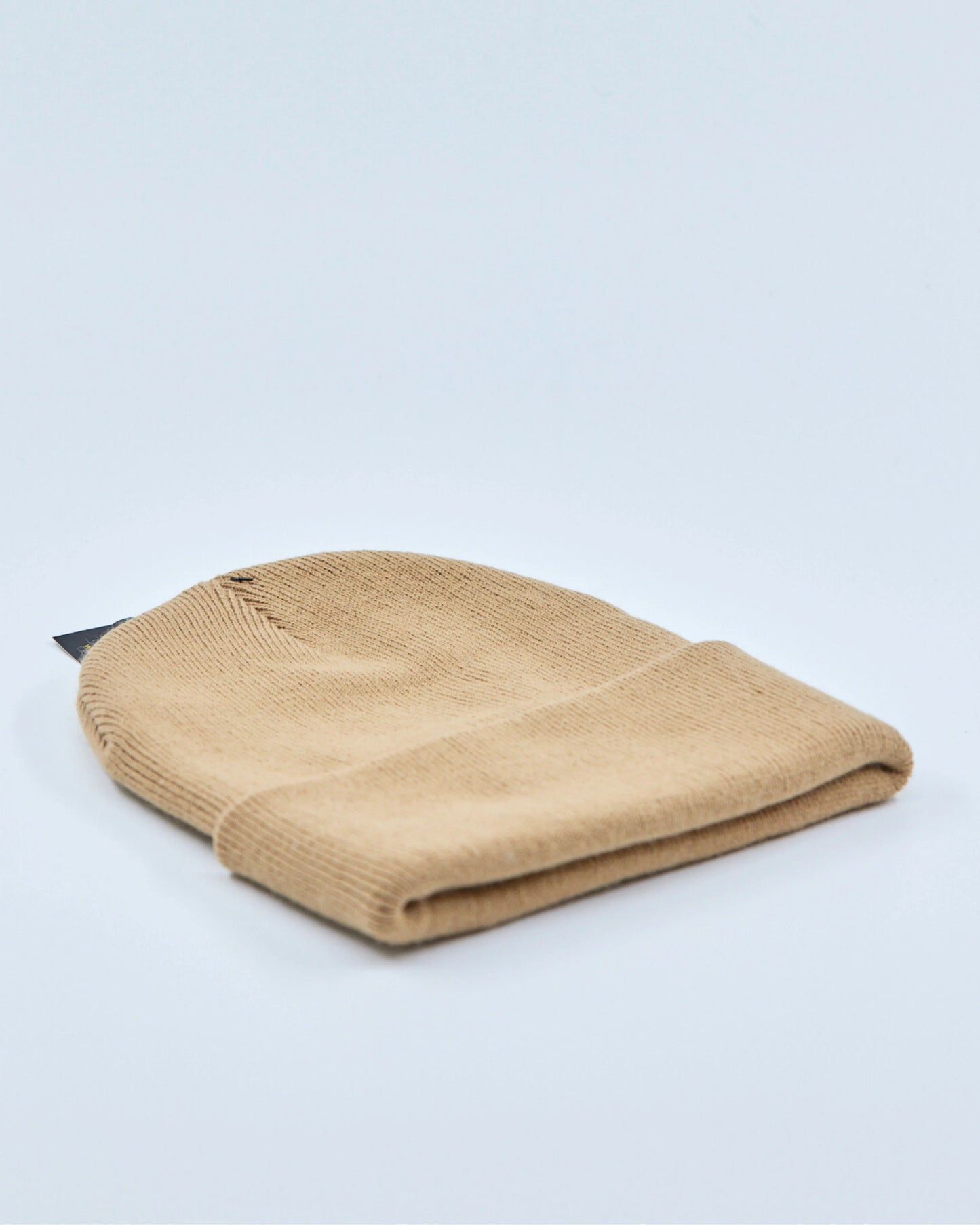 Beige beanie on a light gray background