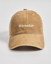 Camel cap with 'Shoreditch' text on a light gray background
