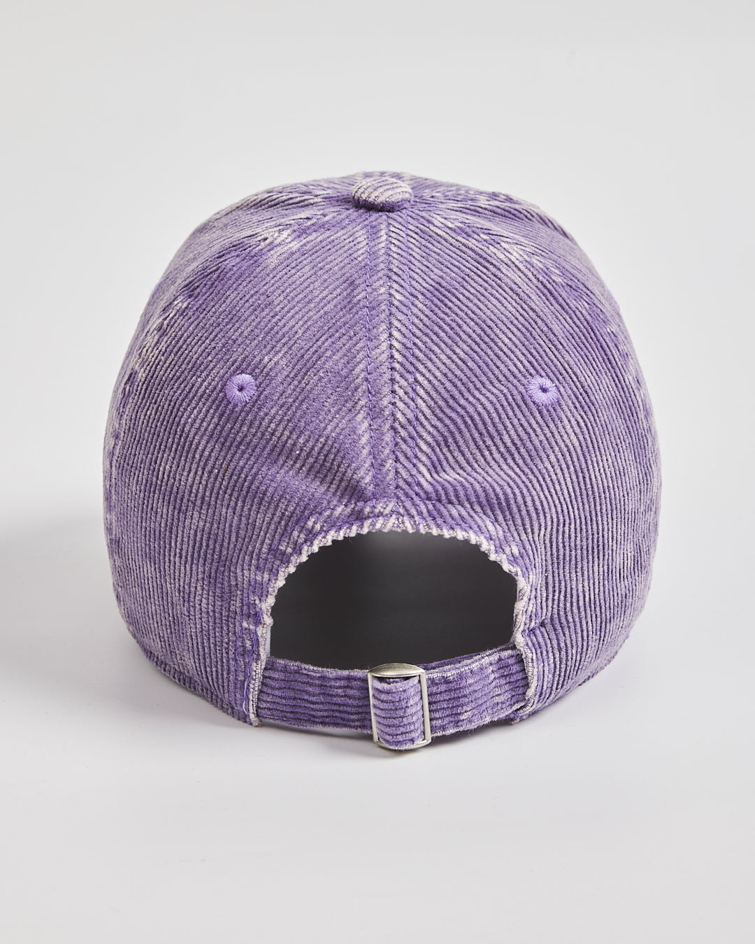 Purple distressed baseball cap on a light gray background