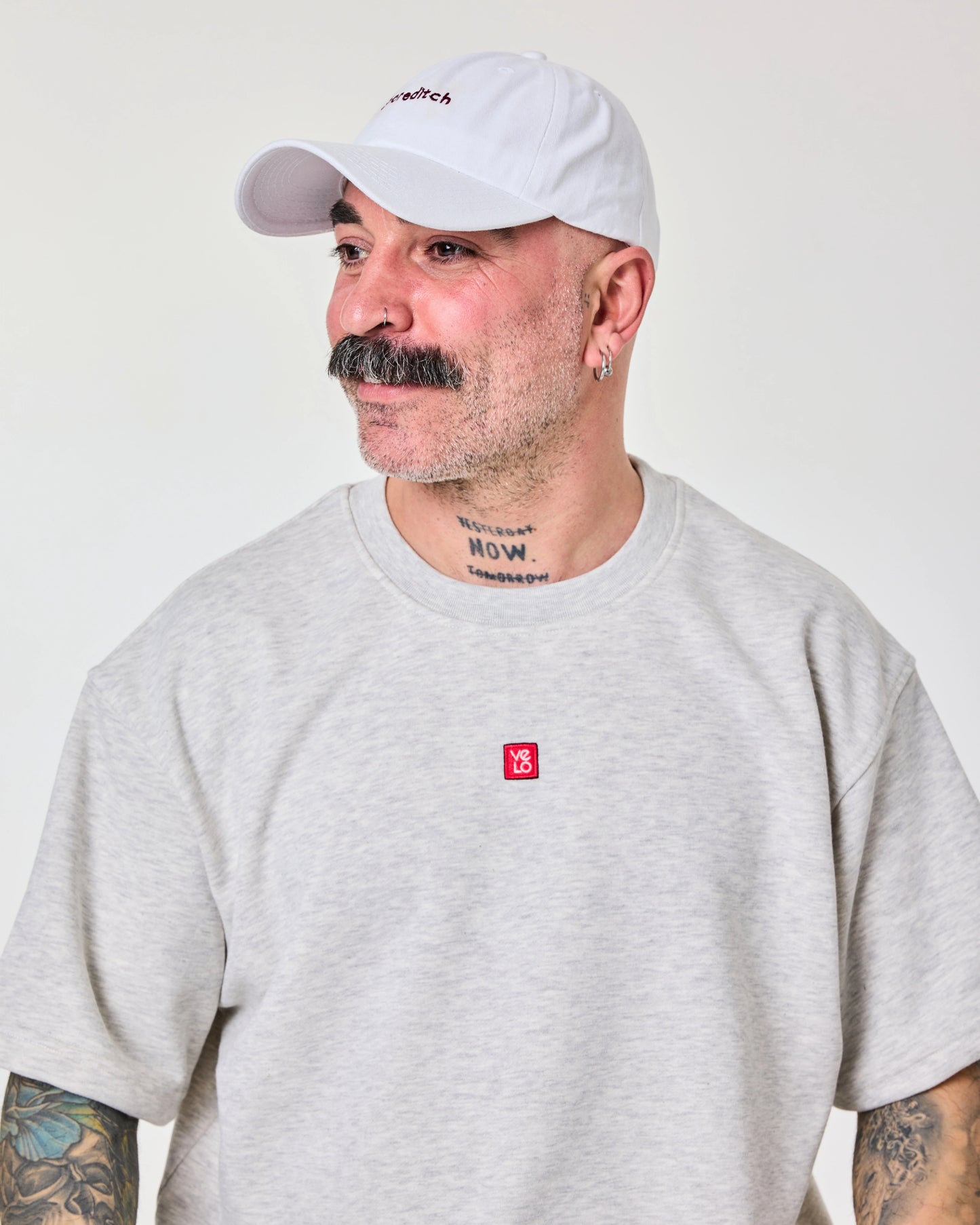 side look of male model wearing Shoreditch embroidered white cap