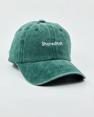 Side view of The Notting Hill Club Dark Green Washed Cap