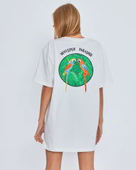 White t-shirt with 'Whisper Paradise' design on the back, worn by a person against a light gray background