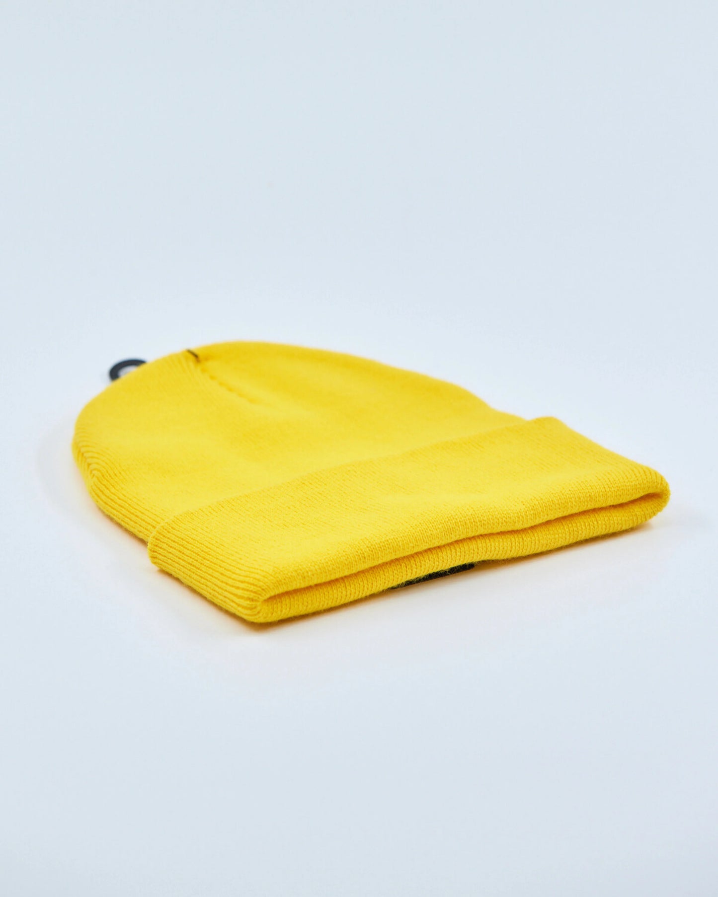 Yellow beanie on a light gray background