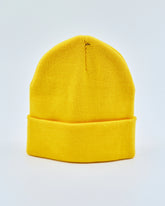 Yellow beanie on a light gray background