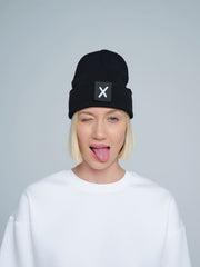 women wearing black beanie with X letter patch on it
