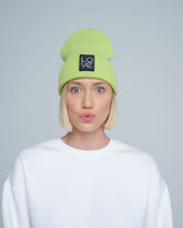 model wearing light green patch ready beanie with LOVE text patch on the front