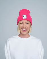 women wearing neon pink beanie with a cat design patch on the front