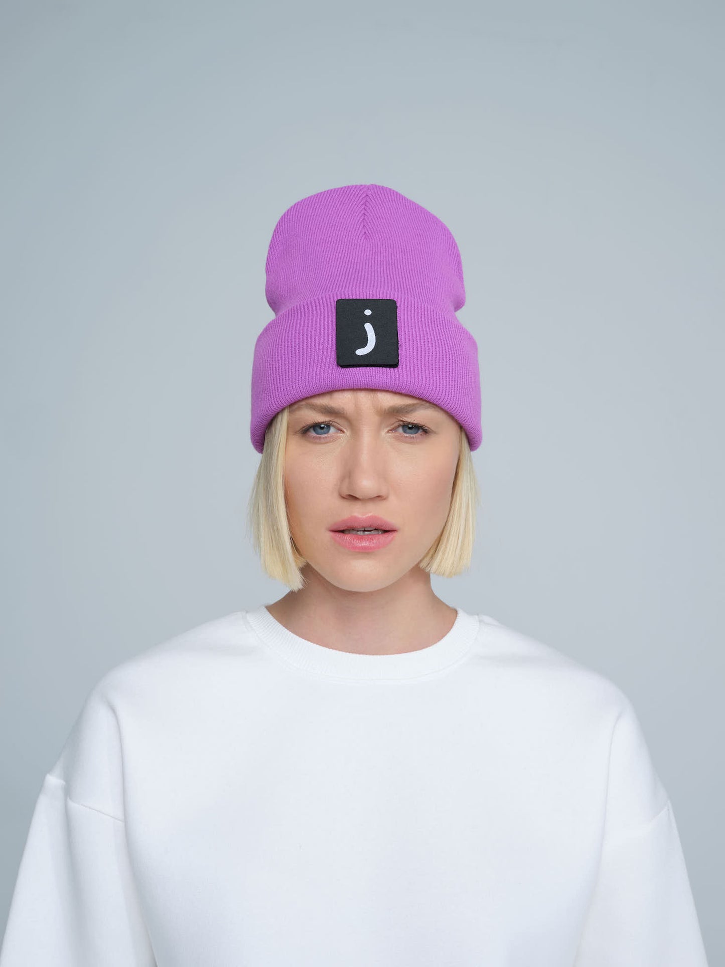 female person wearing purple patch ready beanie