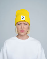 front look of women wearing yellow beanie with Z letter patch