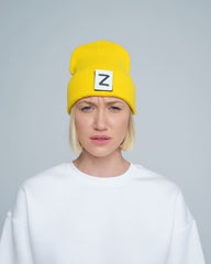 front look of women wearing yellow beanie with Z letter patch