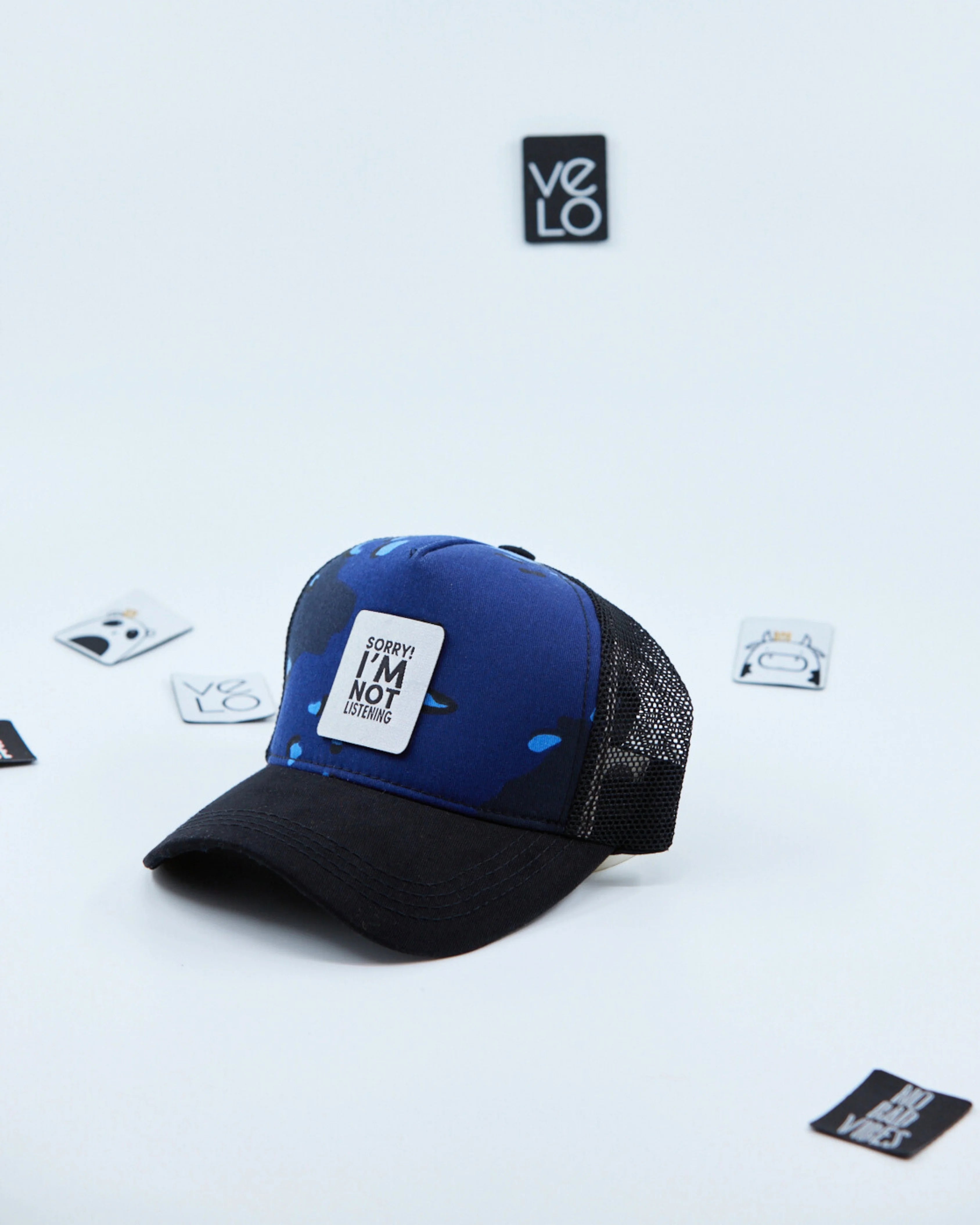 Side view of Blue Camo and Black Customisable Trucker Cap with patches