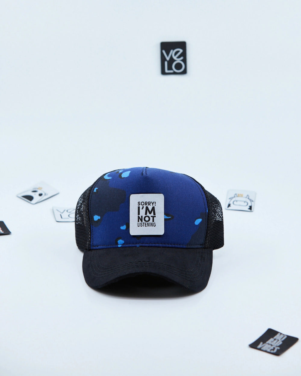 Front view of Blue Camo and Black Customisable Trucker Cap
