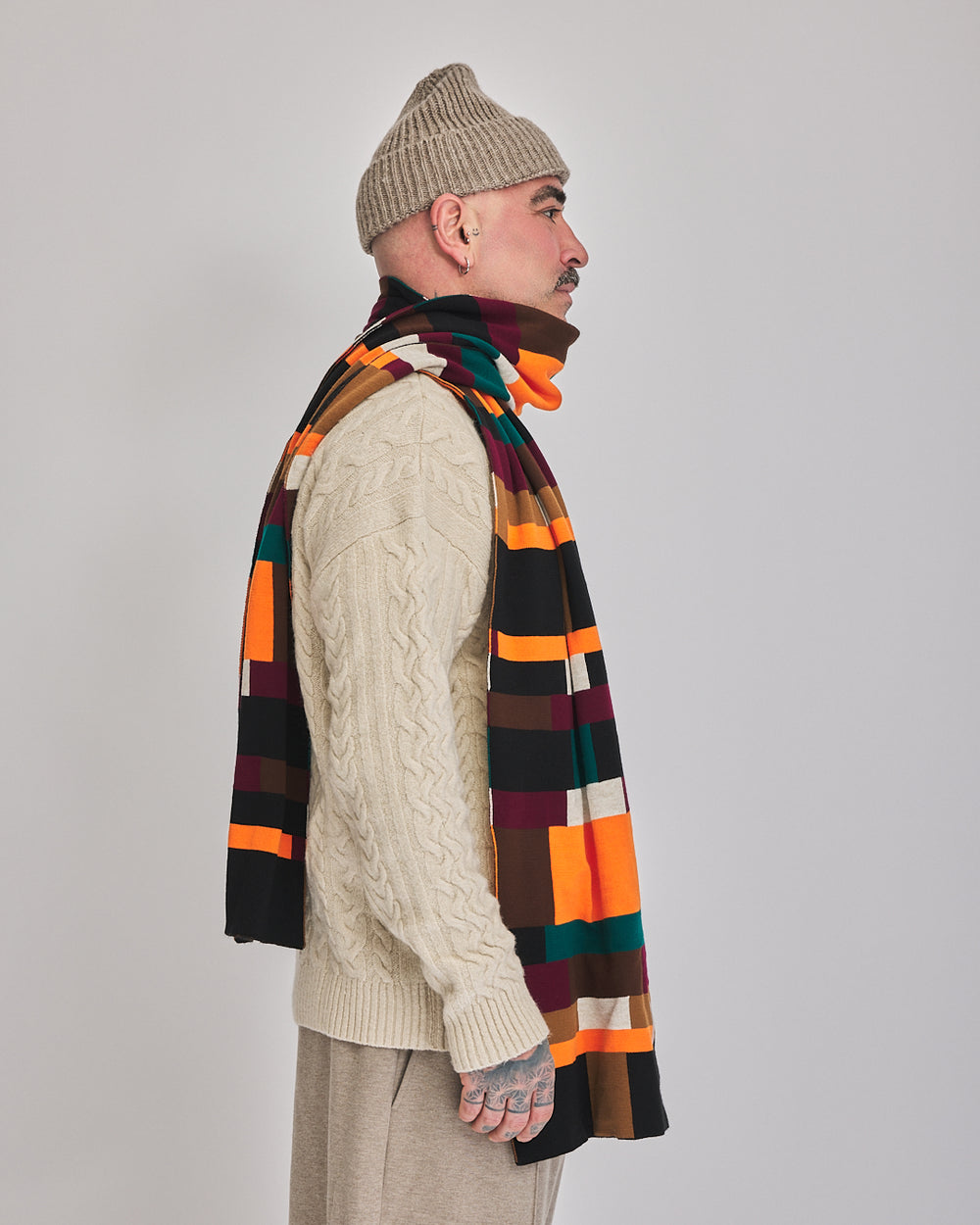 Brick Grid long acrylic scarf styled with cream knitwear, side view