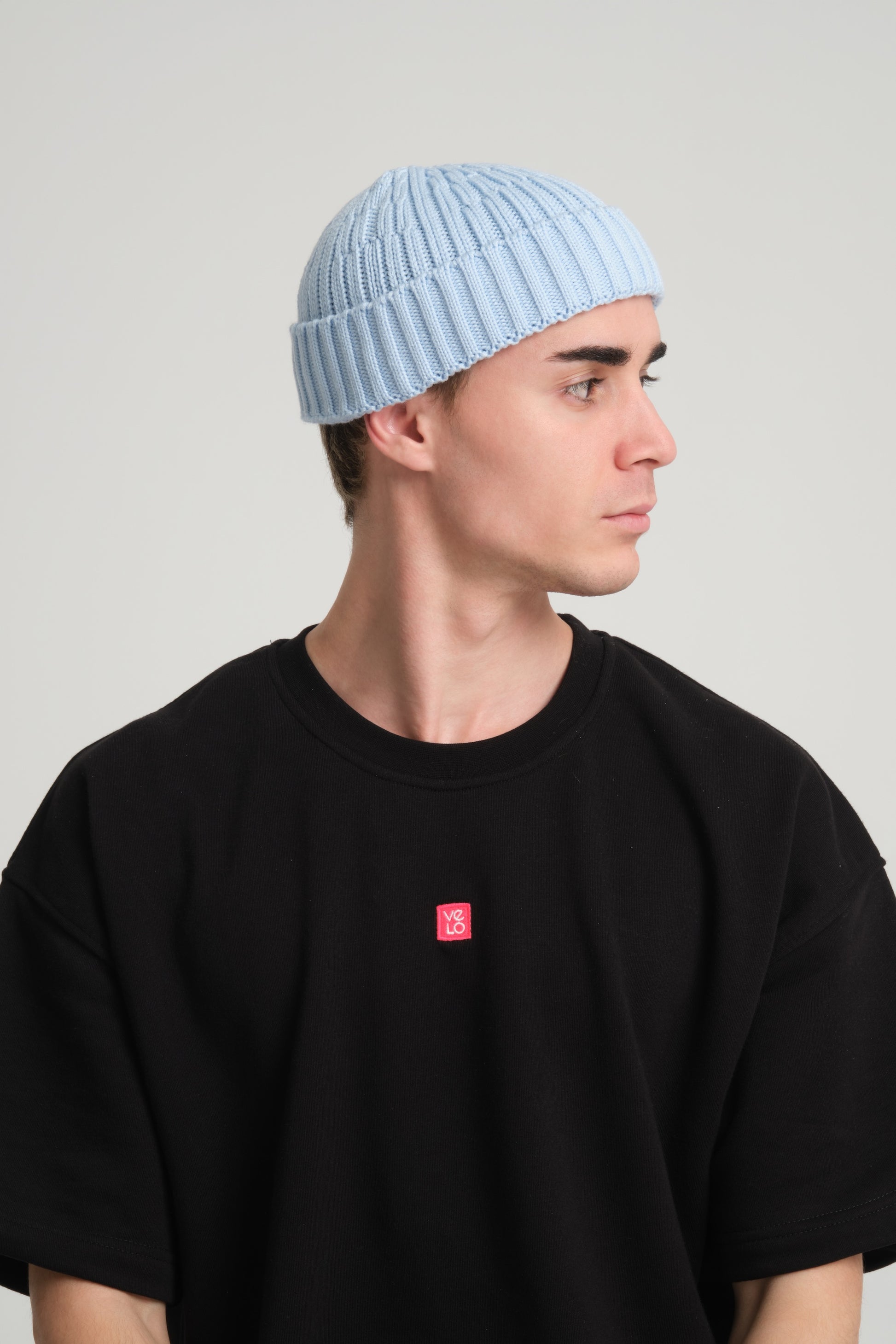 side view of a man wearing Baby Blue Fisherman Beanie