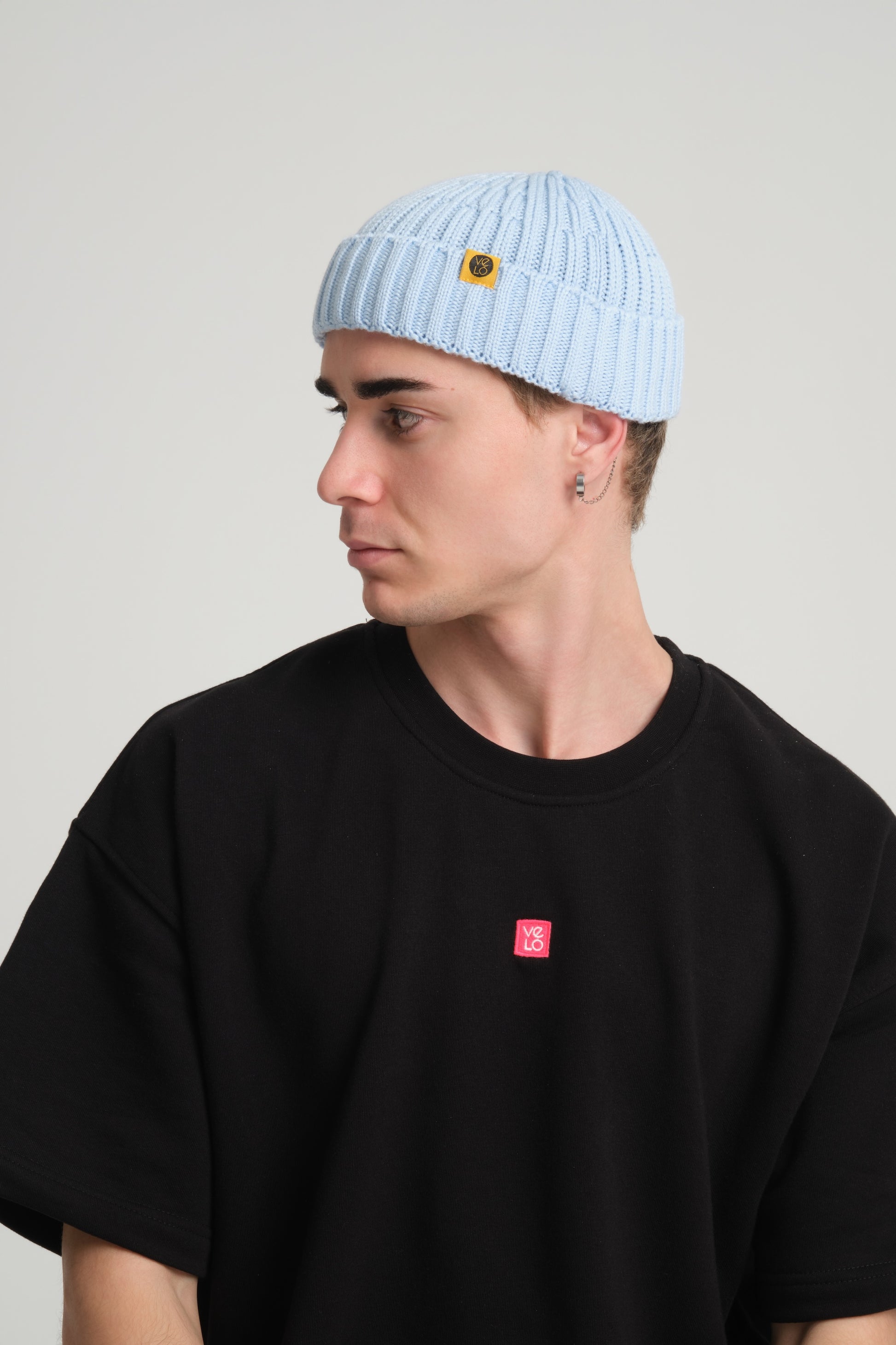 side view of a man wearing Baby Blue Fisherman Beanie