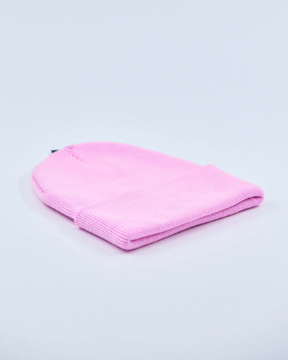 Baby pink beanie on a light gray background