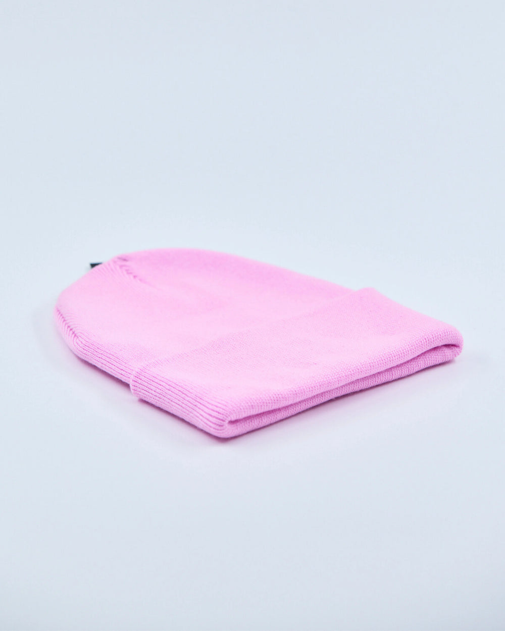 Baby pink beanie on a light gray background