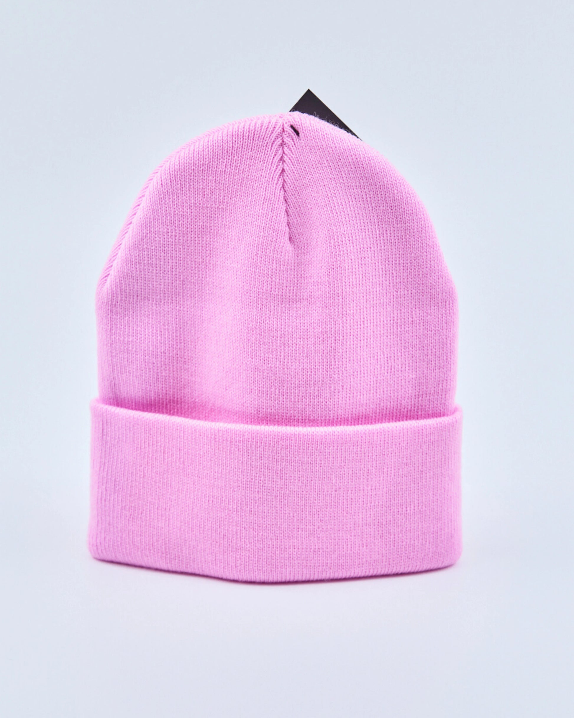 Baby pink beanie on a light gray background