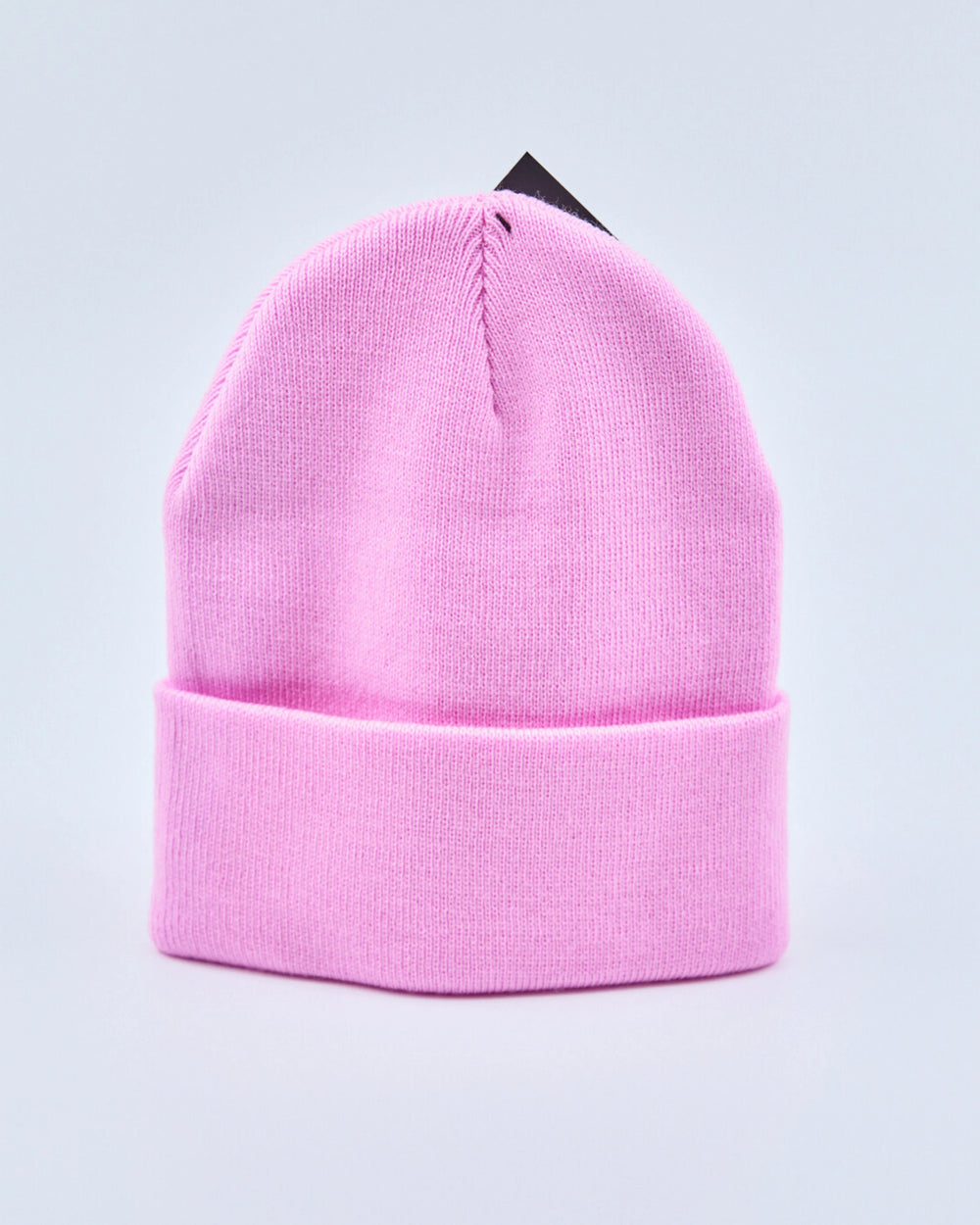 Baby pink beanie on a light gray background