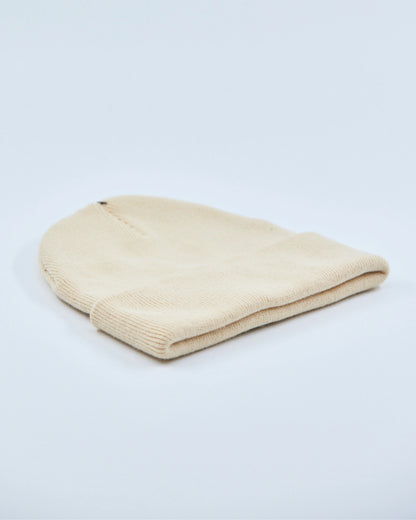 Beige beanie on a light gray background