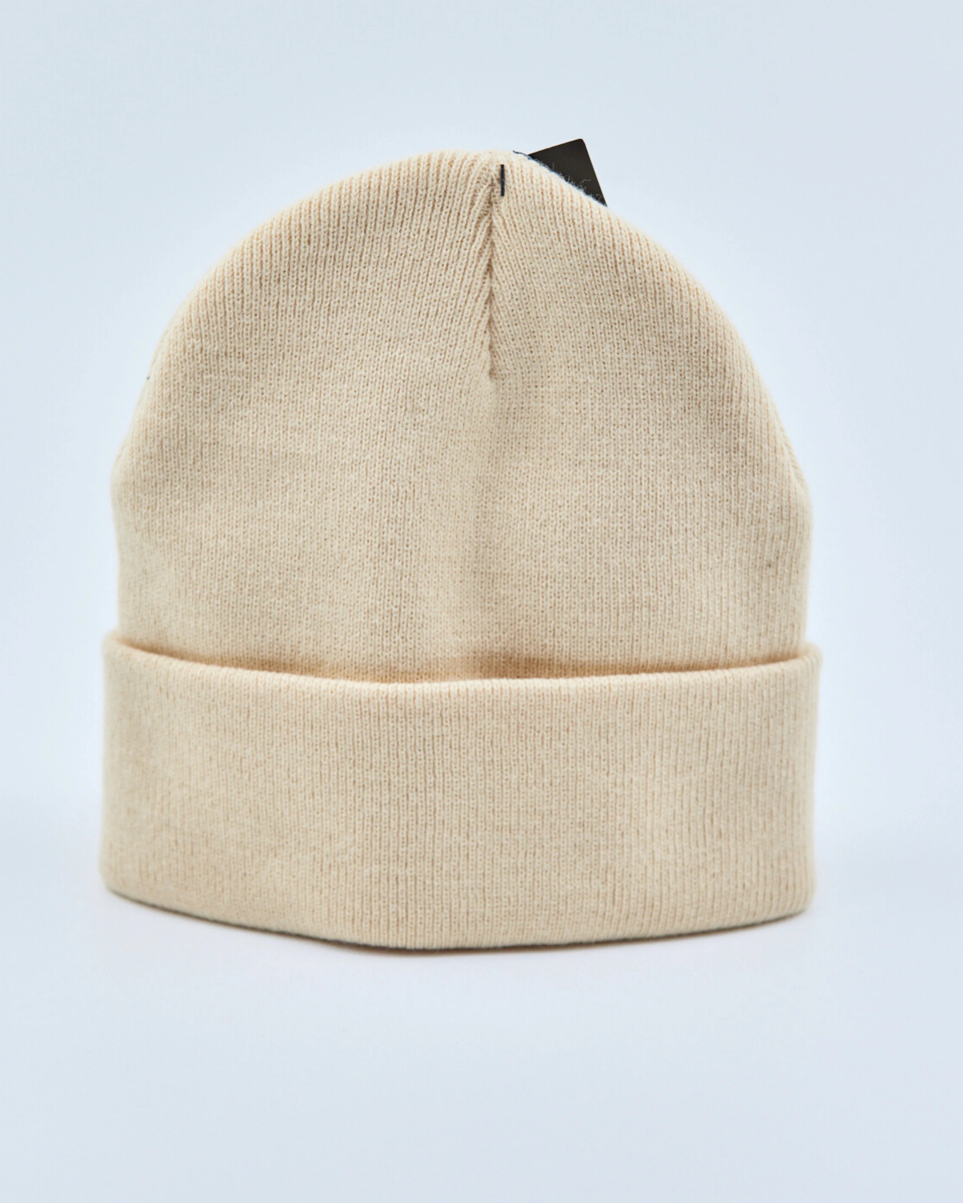 Beige beanie on a light gray background