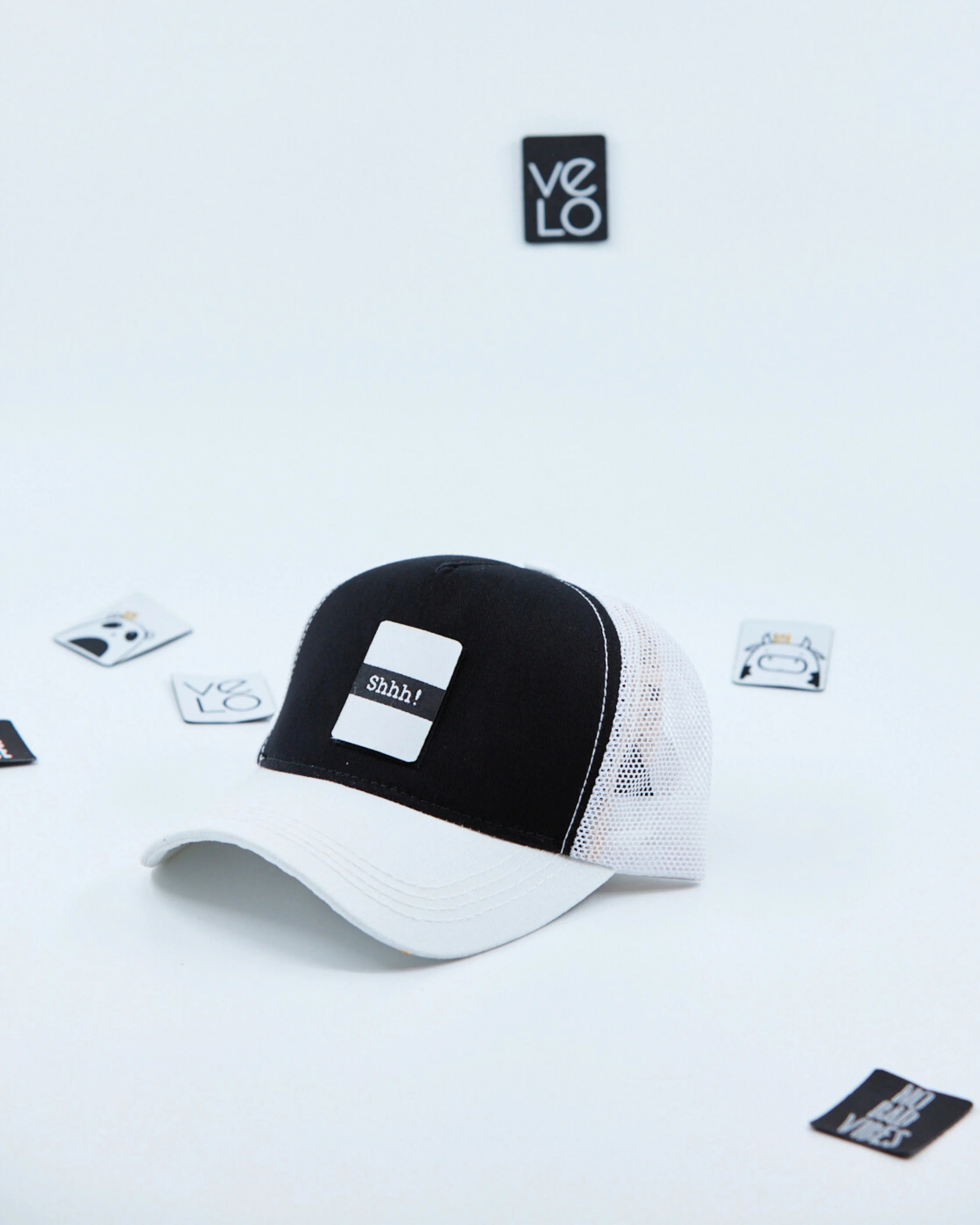 Side view of Black and White Customisable Trucker Cap with patches