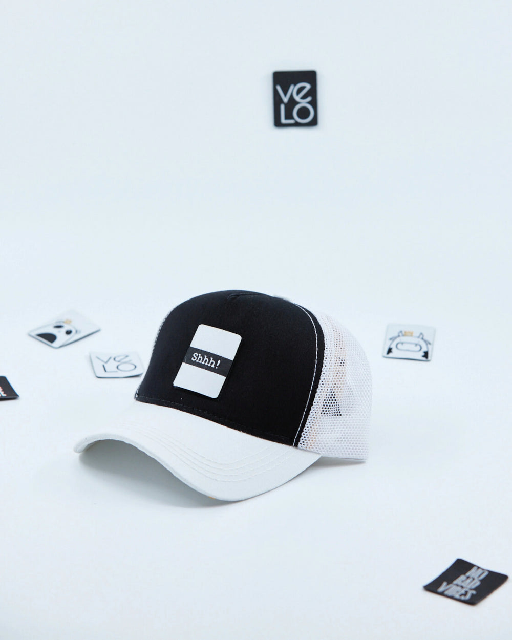 Side view of Black and White Customisable Trucker Cap with patches