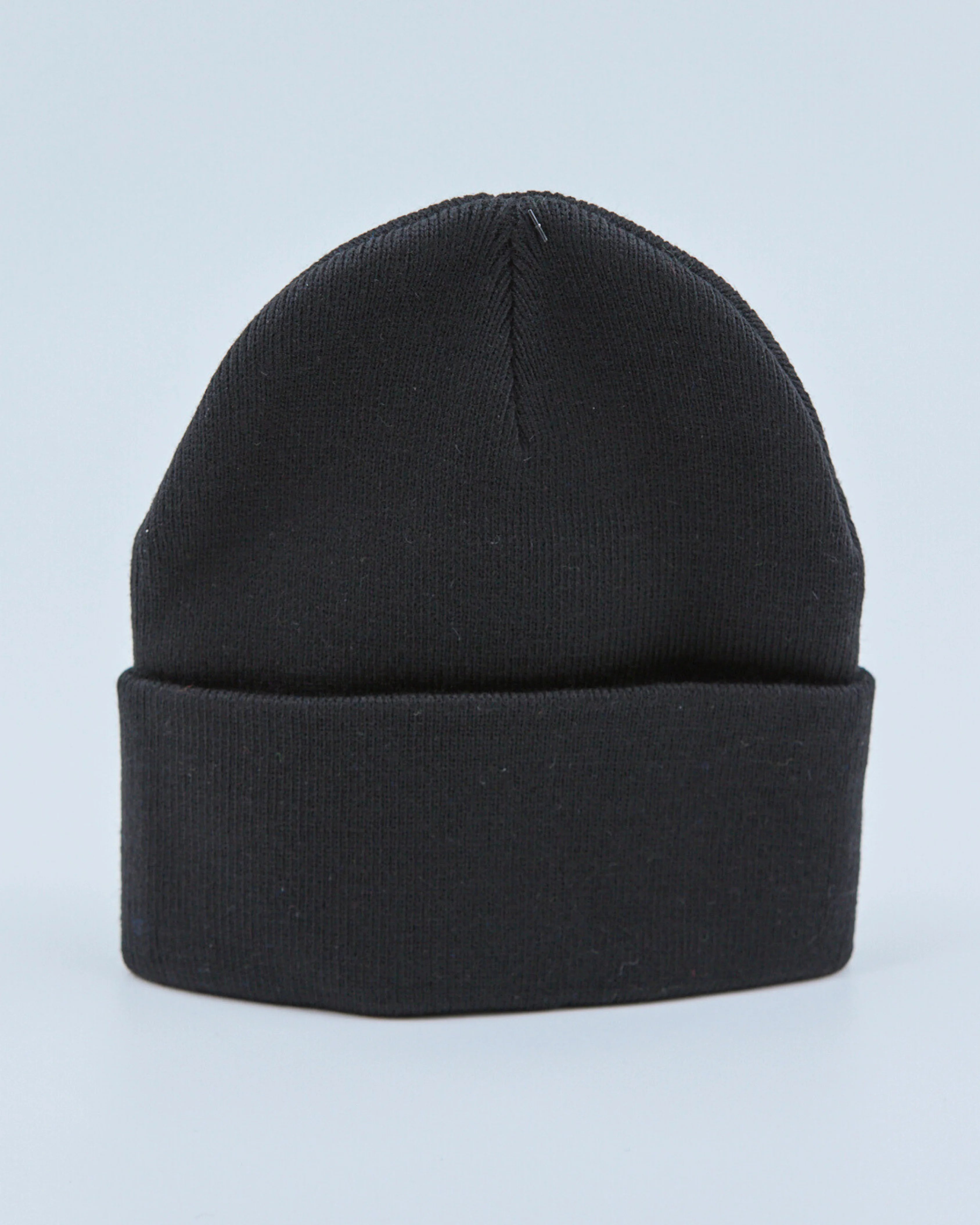 Black beanie on a light blue background