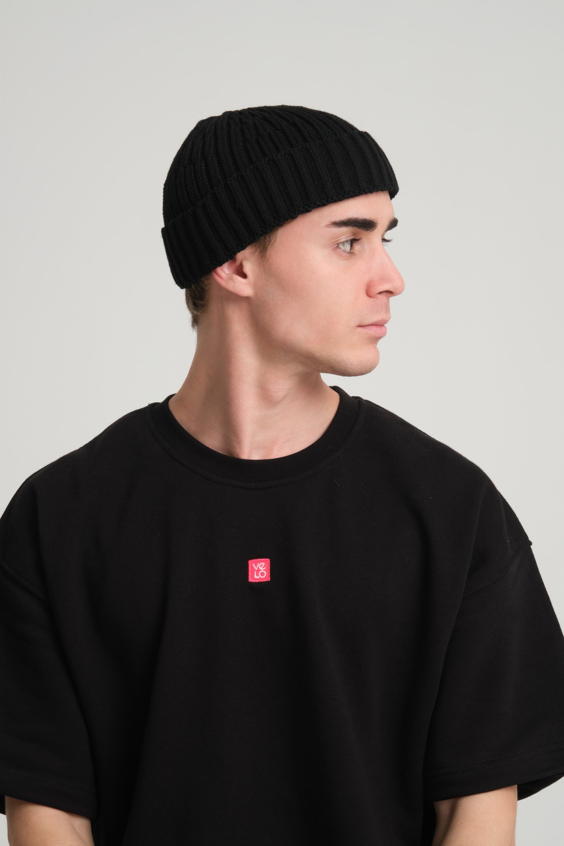 side view of a man wearing Black Fisherman Beanie