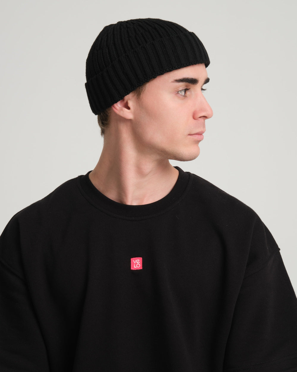 side view of a man wearing Black Fisherman Beanie