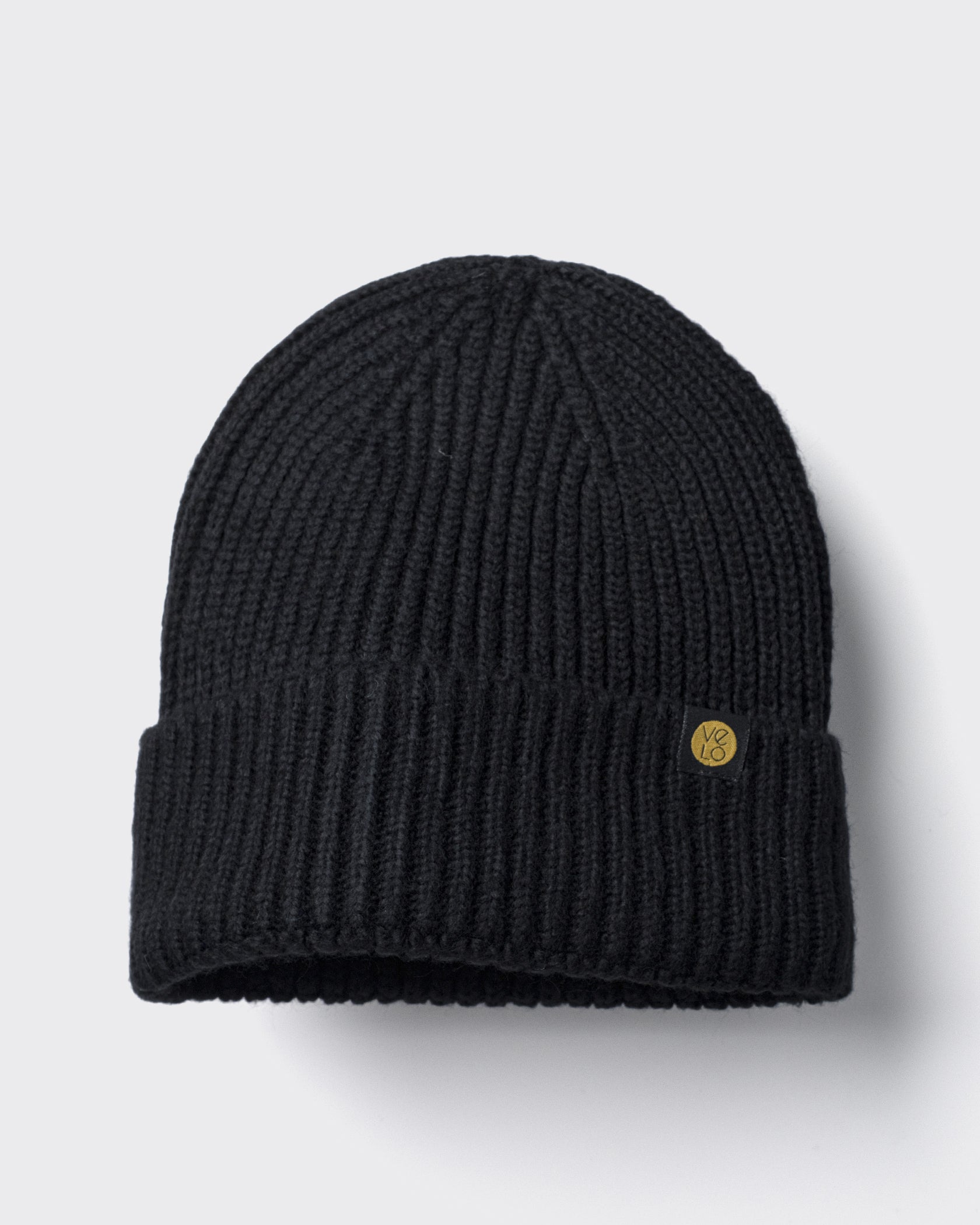 Black Lux Beanie on a light gray background