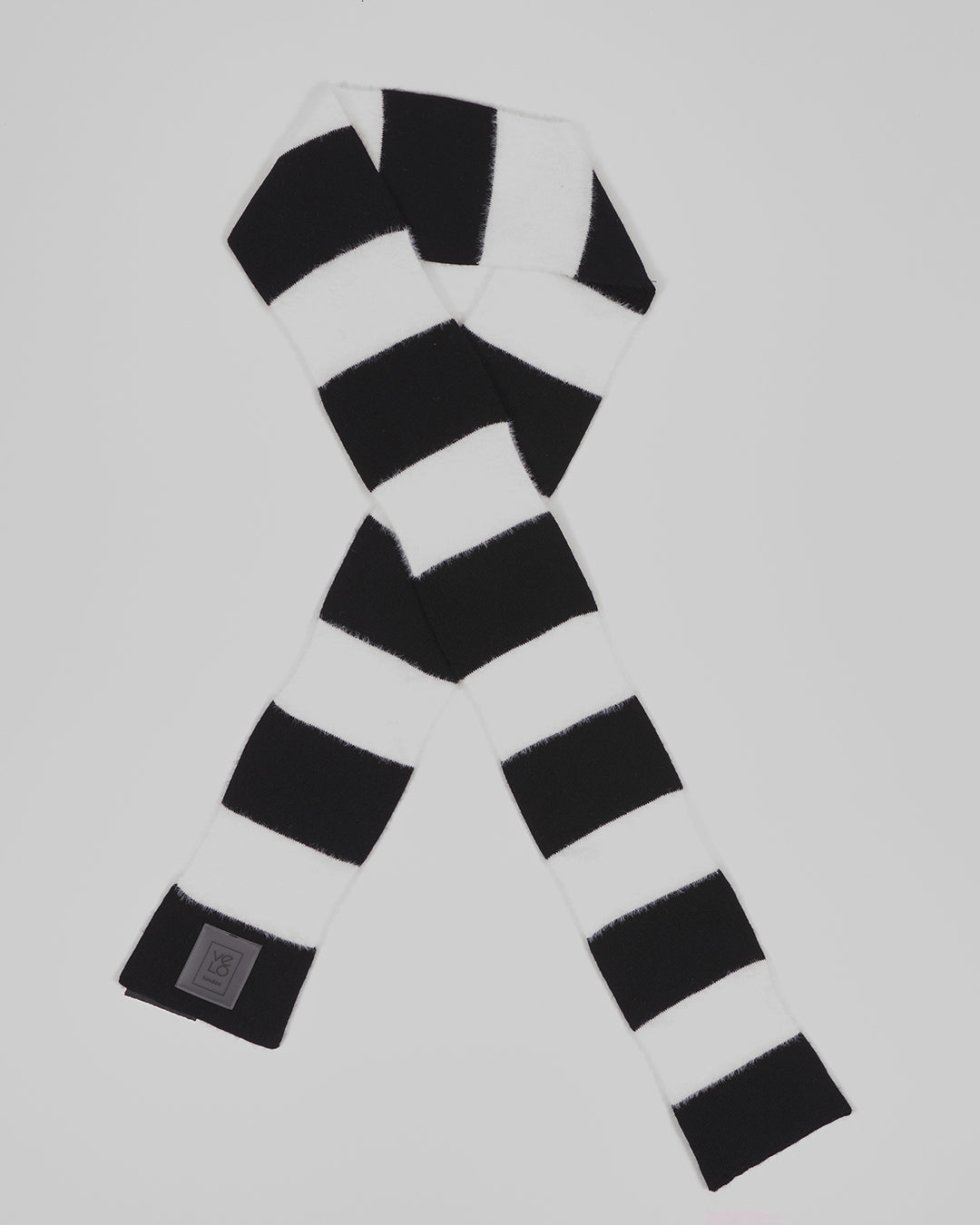 Black & White Lite unisex acrylic scarf flat lay in crisp black and white