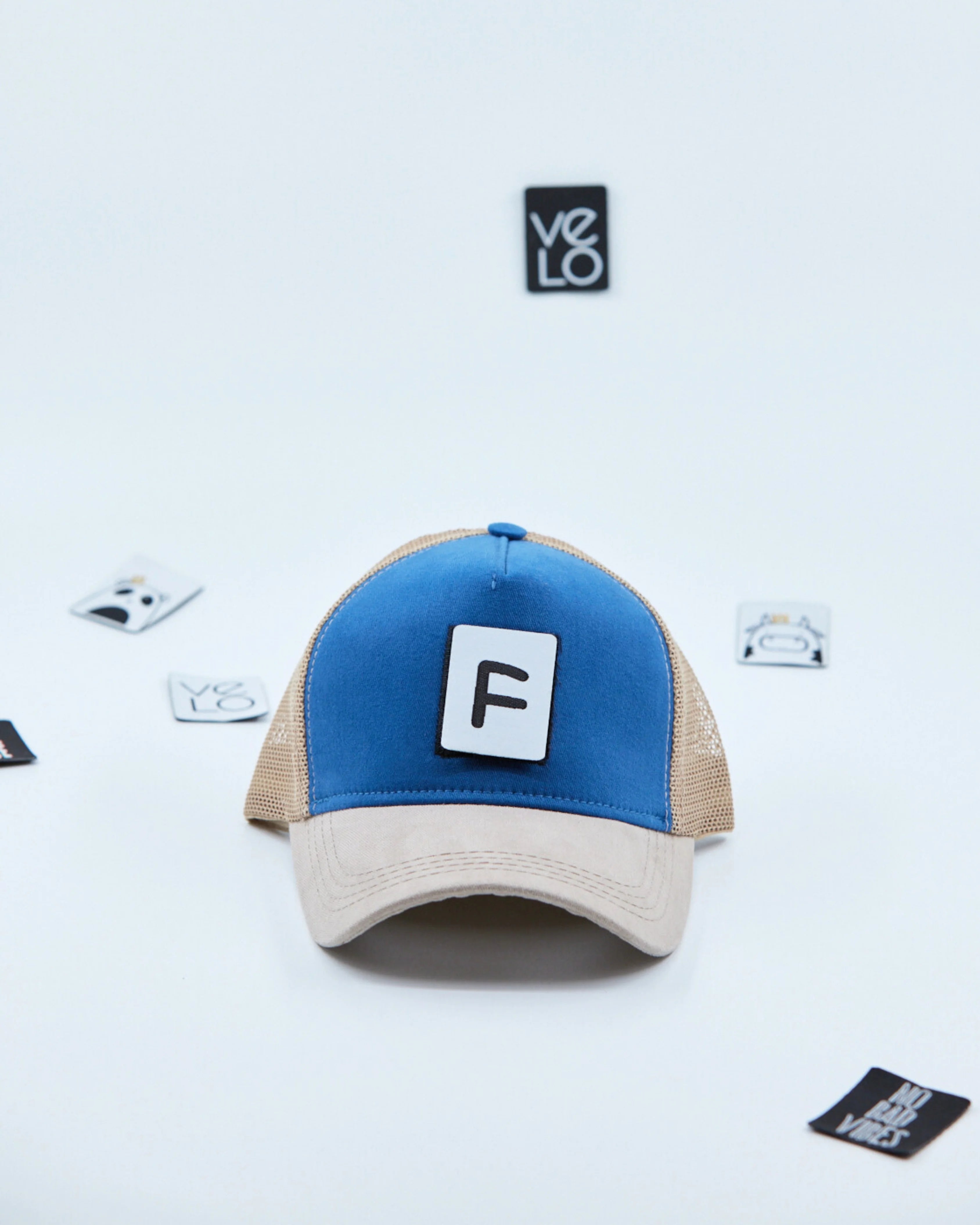 Front view of Blue and Beige Customisable Trucker Cap with patches